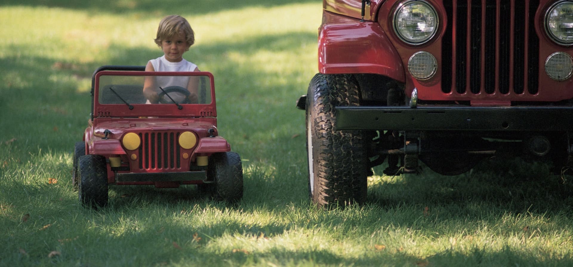 A little Jeep beside a full-size Jeep in the Dougan family photograph